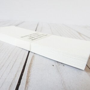 May include: A stack of white blank note cards with the text "Remarkable Notes, 100 Count, Lightly Colored, Watercolor Paper" printed on the top card.