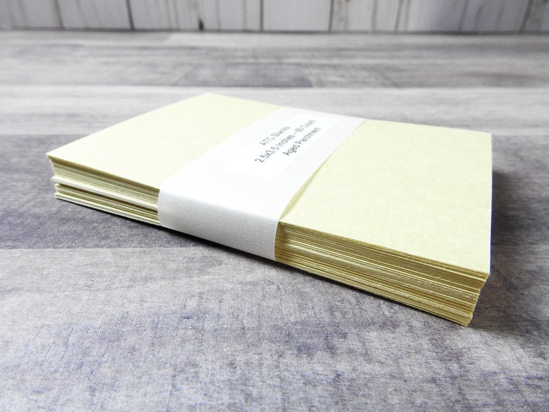 May include: A stack of 250 blank ivory note cards with a white label that reads "FTC Stamps 250 5x7 Note Cards 100lb Paper".