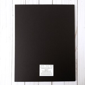 May include: Black framed print with the title "Sometimes Do You See The Beauty" printed on a white label. The label also includes the artist's name, "L. Lovely Art", and the year "2012".