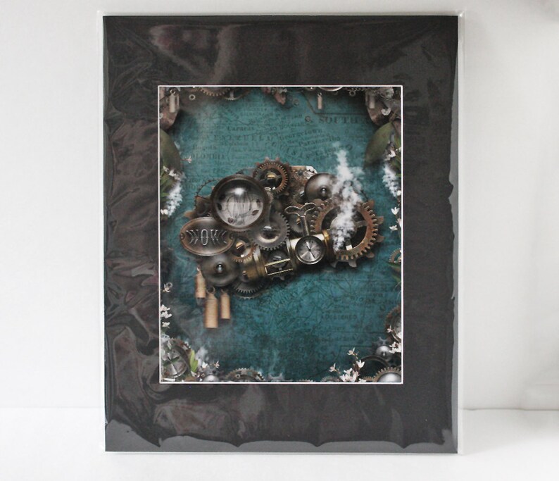 May include: A steampunk-inspired print featuring a collection of gears, cogs, and other mechanical elements on a teal background. The print is framed with a black mat.