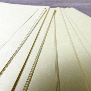 May include: A stack of off-white paper sheets with a subtle textured surface.