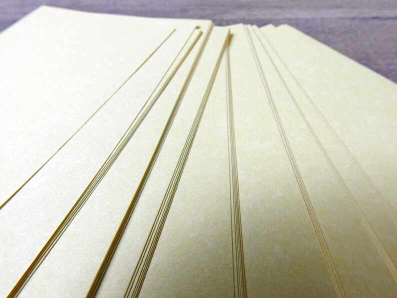 May include: A stack of off-white paper sheets with a subtle textured surface.