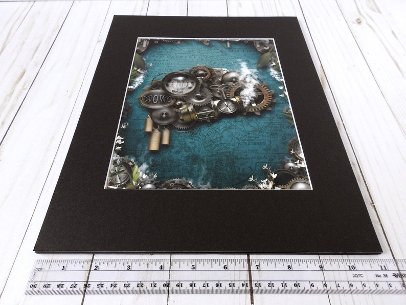 May include: A framed print of a steampunk-style illustration featuring a brain made of gears and cogs on a blue background with white flowers.