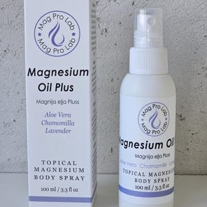 May include: A white box and a matching white spray bottle of Mag Pro Lab Magnesium Oil Plus. The packaging features purple text and branding, listing ingredients including Aloe Vera, Chamomile, and Lavender. Each container is labelled 100 ml / 3.3 fl oz.