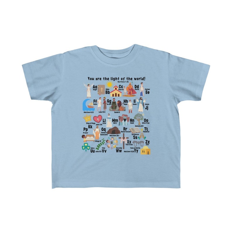 May include: Light blue children's t-shirt with a colorful alphabet design featuring illustrations of biblical figures and scenes. The shirt has the text "You are the light of the world!" and "Matthew 5:14" printed on it.