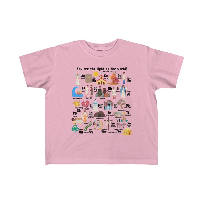 May include: A pink children's t-shirt with a colorful alphabet design featuring illustrations of religious figures and symbols. The text "You are the light of the world!" is printed at the top of the shirt.  Matthew 5:14