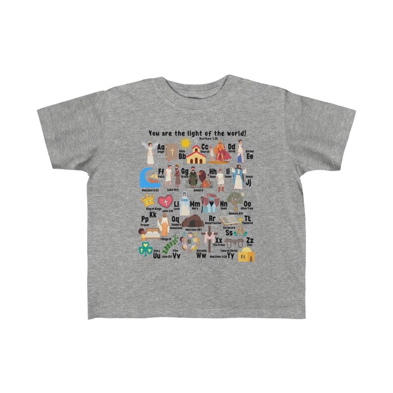 May include: A gray t-shirt with a colorful alphabet design featuring illustrations of biblical figures and scenes. The text "You are the light of the world! Matthew 5:14" is printed on the shirt.