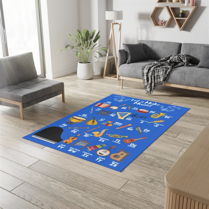 May include: A blue rug with a musical alphabet and illustrations of musical instruments. The rug says "Let's Make Music".