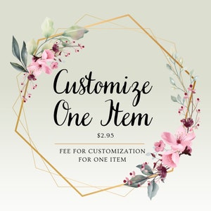 May include: A gold geometric frame with pink and green floral accents. The text "Customize One Item $2.95 FEE FOR CUSTOMIZATION FOR ONE ITEM" is inside the frame.
