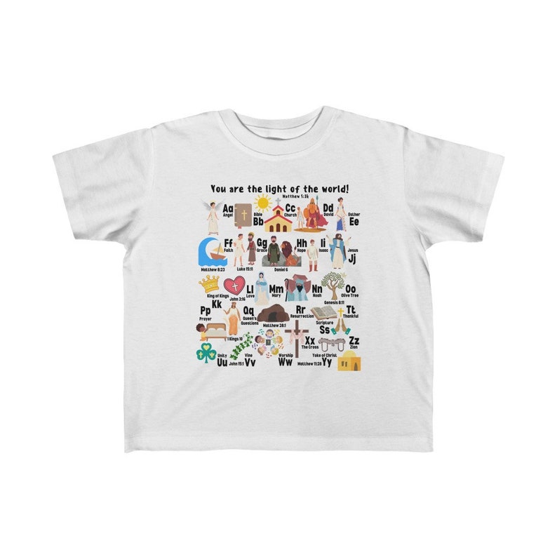 May include: White youth t-shirt with a colorful alphabet design featuring illustrations of Christian themes. The shirt has the text "You are the light of the world!" and "Matthew 5:14".