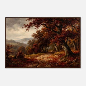May include: A landscape painting in a dark wood frame depicting a forest path during autumn. Large trees with deep red and brown foliage dominate the scene, with fallen leaves covering the ground. Distant mountains are visible under a cloudy sky.
