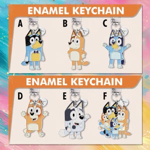 May include: Enamel keyrings featuring cartoon dog characters in various poses. The keyrings are in different colours, including blue, orange, and black, with silver-coloured metal hardware. The text "ENAMEL KEYCHAIN" is displayed at the top of the image.