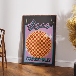 May include: A framed rectangular wall art print featuring a checkered yellow and red disco ball centred on a purple background. The word "disco" is written in a cursive pink font above the ball, and "OCCASIONALLY" is in blue block letters below.