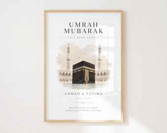 May include: A framed wall print featuring the text UMRAH MUBARAK TO A DEAR COUPLE, AHMAD & FATIMA, NOV 2026, and May Allah accept your Umrah, and grant you a lifetime of blessings, with a watercolor illustration of the Kaaba.