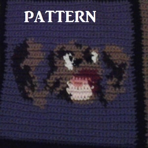 May include: Crocheted square featuring a brown and white dog face with a pink nose and mouth. The square is surrounded by a purple border and the word "PATTERN" is written above the dog.