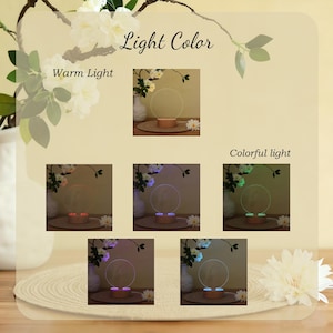 May include: A decorative lamp with a circular design, shown with warm and colorful light options. The lamp sits on a wooden base, with the words "Light Color" and "Warm Light" visible.