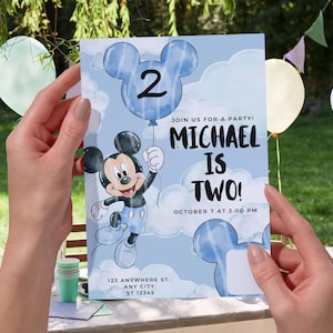 May include: A rectangular birthday party invitation card featuring a light blue sky background with white clouds. The card displays a cartoon mouse character holding a blue balloon shaped like a mouse head with the number 2. Text reads: JOIN US FOR A PARTY! MICHAEL IS TWO! OCTOBER 7 AT 3:00 PM 123 ANYWHERE ST., ANY CITY, ST 12345.