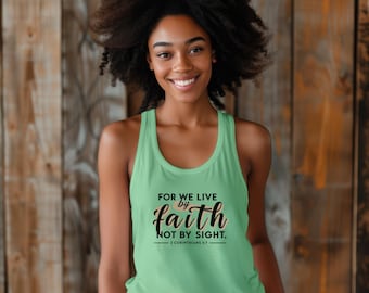 May include: A light green tank top with the text "FOR WE LIVE by faith NOT BY SIGHT. - 2 CORINTHIANS 5:7." The tank top is sleeveless and has a rounded neckline. The background is a wooden wall.