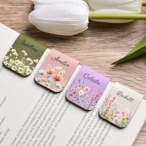 May include: Four rectangular magnetic bookmarks with textured surfaces, each featuring a unique floral print and a name printed in black script: Willow on olive green, Amelia on light pink, Celeste on lavender, and Beckett on cream.