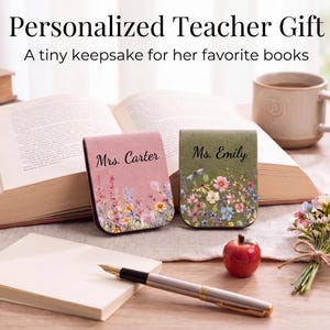 May include: Two rectangular magnetic bookmarks featuring floral prints and personalised names. One bookmark is pink with the text Mrs. Carter, and the other is green with the text Ms. Emily. Both display colourful wildflower illustrations.