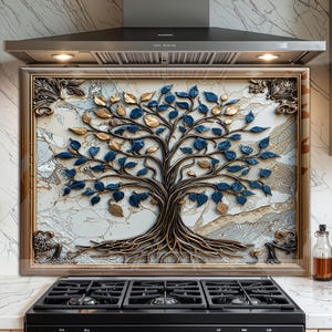May include: A framed wall art piece featuring a tree design with blue and gold leaves. The tree's trunk and roots are brown, set against a marble-like background. The frame is a light brown color, and the artwork is displayed above a black stove.