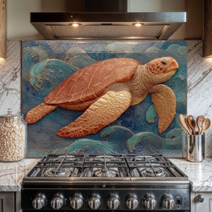 May include: A kitchen splashback with a detailed relief of a sea turtle swimming in ocean waves. The turtle is a warm reddish-brown colour, set against a blue and teal wave background. The splashback is installed above a black gas hob.