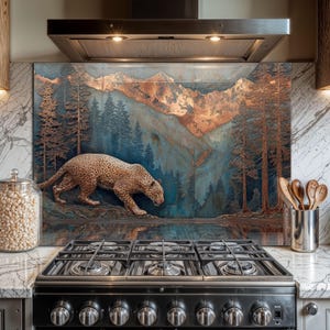 May include: A decorative kitchen splashback with a mountain and forest scene and a leopard. The artwork has copper and blue tones, with detailed trees and a leopard walking near water.