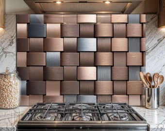 May include: A kitchen backsplash with a 3D textured design in shades of brown, silver, and copper. The backsplash is above a black gas stove. A stainless steel range hood is above the backsplash. A glass jar with white beans and a metal utensil holder are on the countertop.