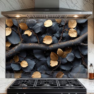 May include: A decorative kitchen backsplash featuring a botanical design. The image showcases a dark gray background with overlapping leaves and branches. Gold-colored leaves are scattered throughout the design, adding a touch of elegance to the kitchen decor.