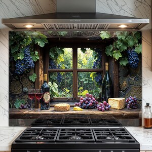 May include: A kitchen splashback depicting a rustic window scene with grapes, wine bottles, and glasses. The image includes a wooden window frame, a stone wall, and a view of lush greenery. A black cooker is in the foreground.