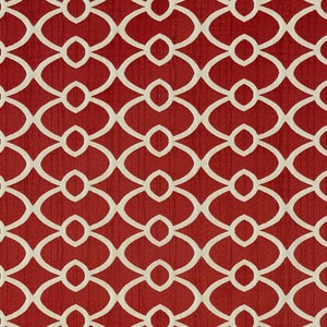 May include: A fabric swatch featuring a repeating geometric pattern of interlocking cream-colored ovals and circles set against a deep red background. The red surface displays a subtle vertical texture, creating a consistent, symmetrical design.