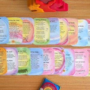 May include: A set of 20 colorful cards with watercolor backgrounds and lyrics for songs to sing throughout the day. The cards feature titles such as "Spring Has Come", "Setting Dressed", "Table Time", "Mother Earth", "Rainbow Bridge", and "Sea Time".