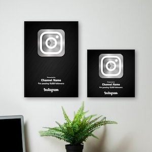May include: Two black plaques with a silver Instagram logo and text that reads "Presented to Channel Name for passing 10,000 followers Instagram".
