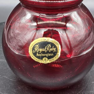 May include: A set of three ceramic mugs with a speckled, cream-colored glaze. Each mug features a different hand-painted floral design in shades of blue, green, and yellow. The mugs have a simple, modern shape.