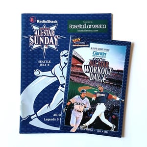 May include: Two baseball-themed event programs. The larger one is for the 2001 All-Star Sunday in Seattle, July 8, with a baseball player graphic. The smaller one is for the 2001 All-Star Workout Day, July 9.