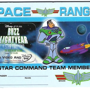 May include: A Space Ranger ID card featuring Buzz Lightyear from Disney Pixar's "Buzz Lightyear of Star Command." The card has a blue background with space-themed graphics, including planets and a purple spaceship. Text includes "Space Ranger" and "Star Command Team Member."