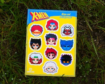 May include: A kiss-cut sticker set featuring various X-Men character faces. The stickers are on a yellow background with the X-Men logo at the top. The sticker set is on a bed of green grass.