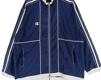 May include: A navy blue jacket with white piping and a zipper closure. The jacket has a Champion logo on the left chest.