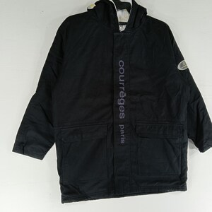 May include: Black hooded jacket with two front pockets and the text "courr&egrave;ges paris" vertically down the front. The jacket has a white and light-colored lining visible in the hood.