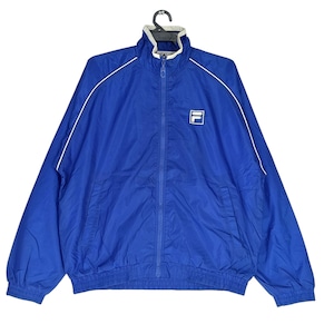 May include: A royal blue zip-up jacket with white trim and a white logo on the chest. The jacket has a high collar and a full-length zipper. The jacket is made of a lightweight material, perfect for layering.