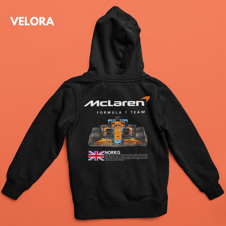 May include: Black hooded sweatshirt with a McLaren Formula 1 Team logo, a race car, and the text "NORRIS" printed on the back.