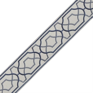 May include: Decorative trim featuring a repeating geometric pattern. The trim has a light beige background with a dark blue border and a lighter blue interwoven design. The design is a series of interlocking shapes.