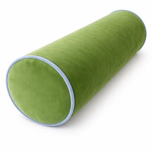 May include: A cylindrical green bolster pillow with a light blue trim. The pillow is made of a soft, velvety fabric. This decorative pillow is designed for comfort and adds a pop of color to any room. It is approximately 24 inches long.