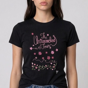 Unraveled Tour Baby Tee, Fitted Black Concert Tee with Pink Floral Script, Livies Gift