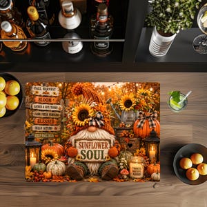 May include: A rectangular decorative mat featuring a gnome wearing a sunflower-adorned hat, holding a sign that reads SUNFLOWER SOUL. The scene includes pumpkins, lanterns, a wooden signpost with fall phrases, and sunflowers on a rustic autumn background.