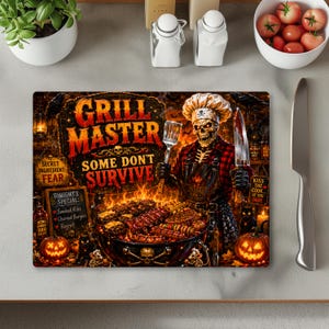 May include: A rectangular cutting board featuring a graphic of a skeleton chef wearing a toque and apron, grilling food. The text reads Grill Master Some Don't Survive, Secret Ingredient Fear, and Tonight's Special Smoked Ribs, Charred Burgers, Regret.