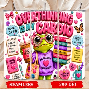 May include: A cylindrical tumbler featuring a green frog wearing pink glasses and a purple sweatshirt with the text Professional Overthinker. The design includes the text Overthinking Is My Cardio, a to-do list, books, and various pink hearts.