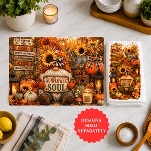 May include: A rectangular kitchen towel and a matching print featuring a gnome with a sunflower hat holding a sign that reads SUNFLOWER SOUL. The design includes pumpkins, lanterns, candles, and wooden signs with text like FALL HARVEST and BLESSED.