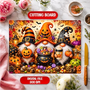 May include: A rectangular cutting board featuring a vibrant Halloween illustration of three gnomes with long white beards. The gnomes wear orange, black, and striped hats, holding a jack-o'-lantern, a candy-filled cauldron, and a coffee cup.