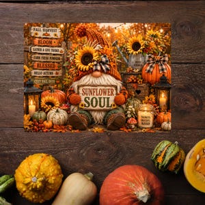 May include: A gnome wearing an orange knit hat with a sunflower and plaid bow, holding a sign that reads SUNFLOWER SOUL. The scene includes a wooden signpost with fall phrases, pumpkins, sunflowers, lanterns, and a jar labeled THANKFUL GRATEFUL BLESSED.